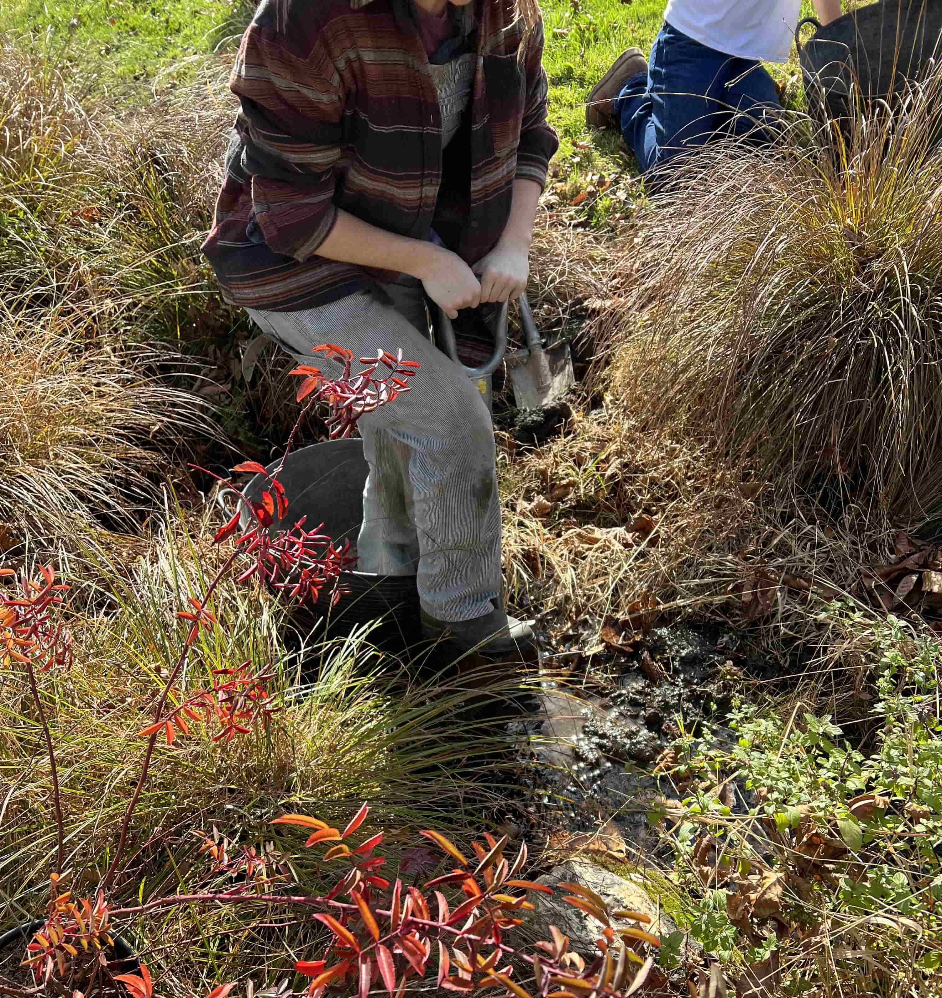 Person digging with hand tools